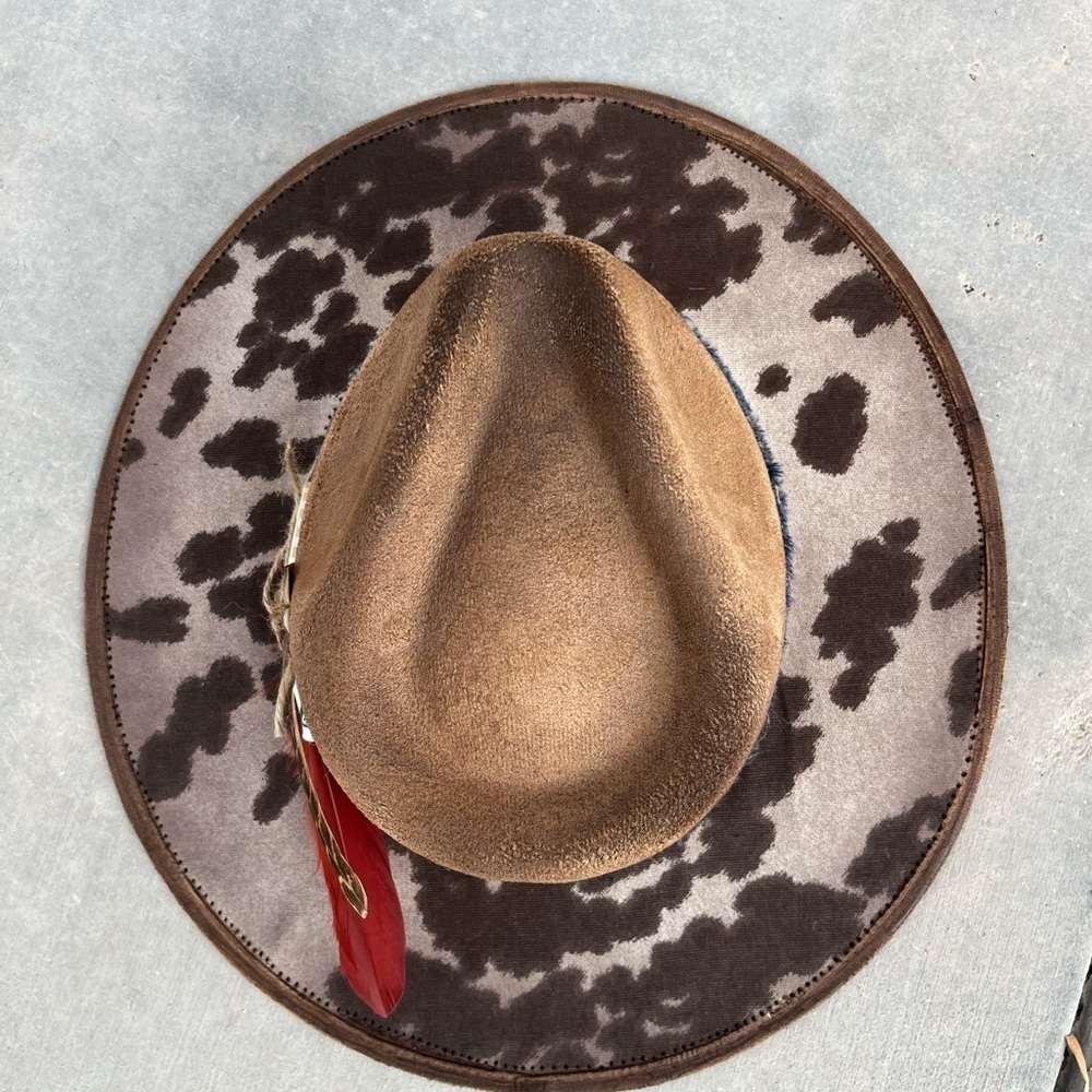Brown cow print rancher style cowboy hat